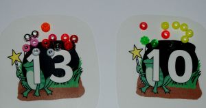 Adding correct number of ingredients to the cauldron. Included in Maths lapbook on ofamilyblog