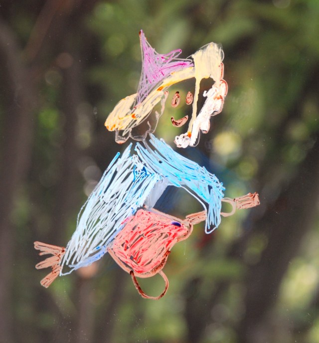 Drawing a witch on the sliding door. Fun Autumn art activity for children to do at home