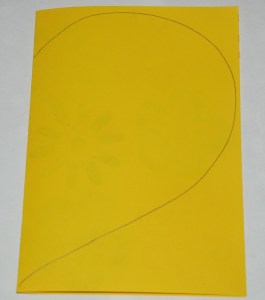 Making an envelope - fold your paper and draw a heart shape on it