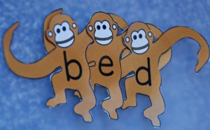 Monkeys all linked together to spell bed