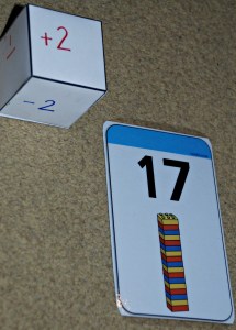 Twinkl lego cards and dice used in the addition and subtraction game on ofamilyblog