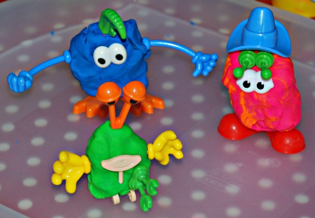 Using the plastic playdough body part set to create all kinds of little monsters