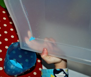 Sand art using a tray to help contain the sand