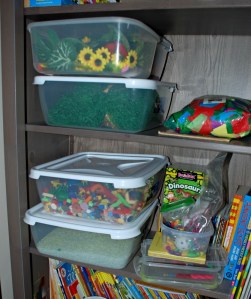Sensory tubs stored on our bookcase for easy access