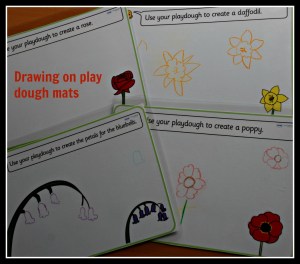 Drawing flowers on play dough mats