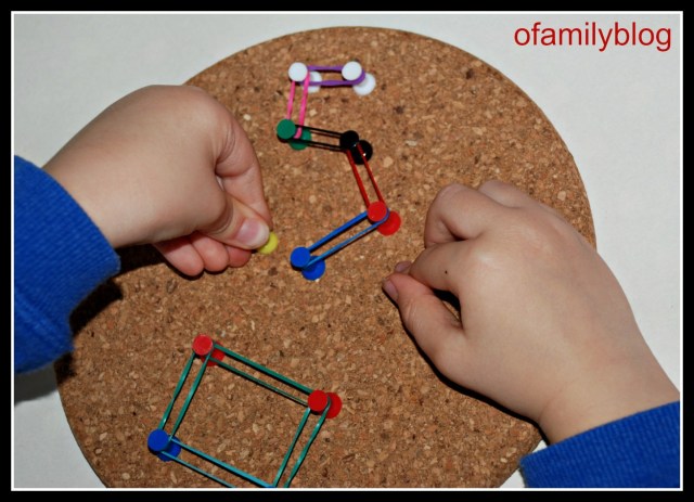 Cork coasters drawing pins and loom bands to create shapes and numbers on ofamilyblog