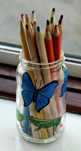 Decorated glass jar using minibeast images from the Twinkl website
