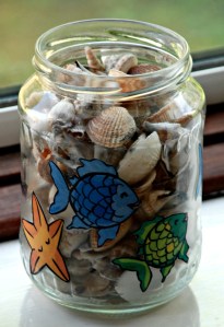 Decorated glass jars using the Rainbow Fish images from the Twinkl website