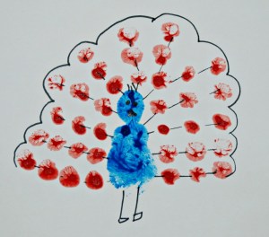 Finger painting a peacock with some details added using a felt tip pen