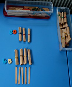 Magnetic numbers and craft sticks to work out tens and ones on ofamilyblog