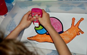Minibeast sand art - using our pritt all purpose glue to trace over the outlines of the snail