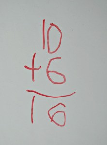 After throwing his dice onto the foam mat he writes out his sum on the white board