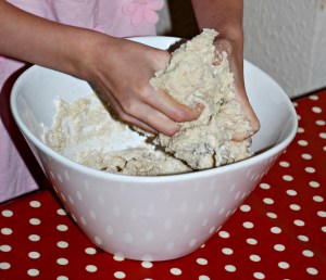 children using their hands to mix the dough