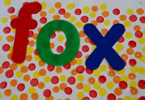 kids created their own dotty paper to use the letter stencils on
