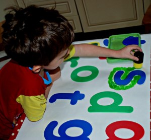 painting over the letter stencils with dabbers