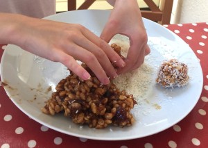 rolling date balls in the coconut is a great baking activity for children