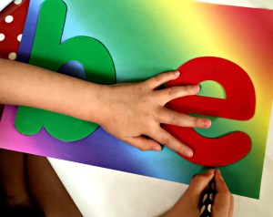 tracing over the letters onto rainbow paper