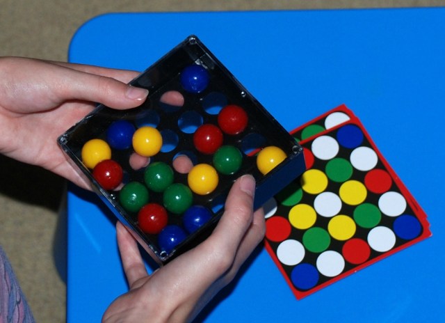 Edushape Tricky Finger game moving the coloured marbles with your fingers so it matches the pattern card