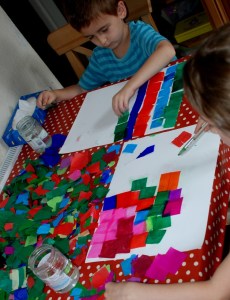 Kids adding tissue paper to card and then using paint brushed to wet the tissue paper so that the colour bleeds