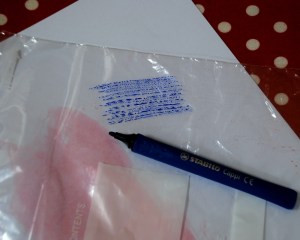 Using the ink from felt tip pens to get a patterned effect on card by adding water and rubbing with a plastic sandwhich bag