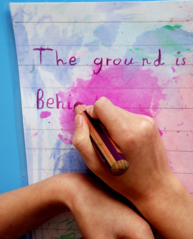 Writing on her laminated pages using the Stabilo 3-in-1 pencils