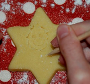 Drawing a smily face onto our cookies