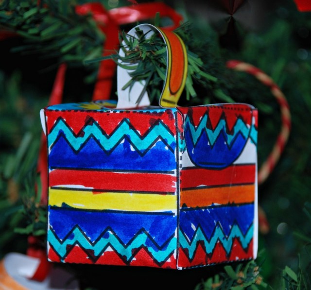 Christmas Box Decoration from Twinkl coloured in, made up and hanging on the tree