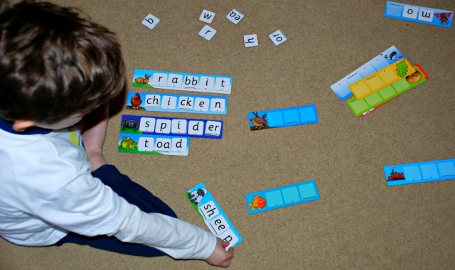 Practicing spelling word with the Orachrd Toys Match and Spell Next steps game