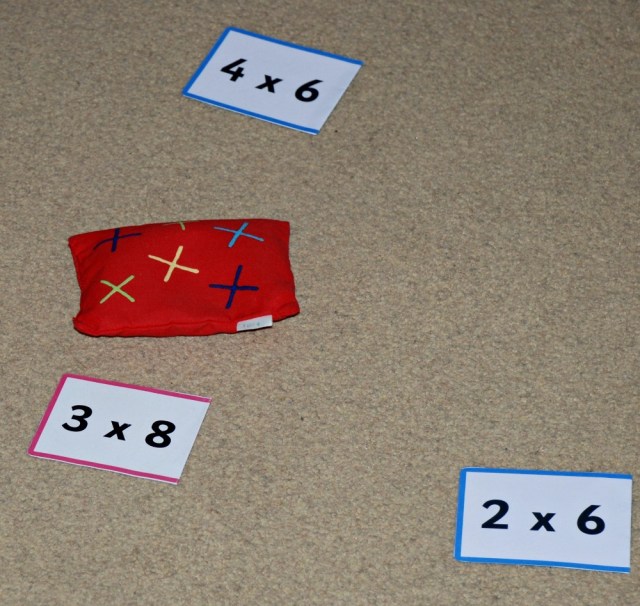 Throw a bean bag and then answer a sum