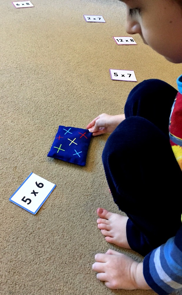 Times table practice with Twinkl's folding cards and some bean bags