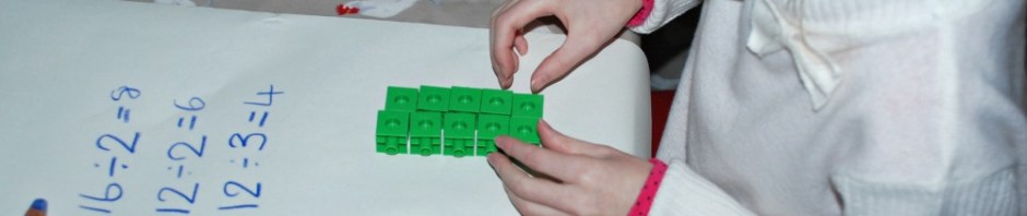 working out division by sharing our snap cubes into equal groups