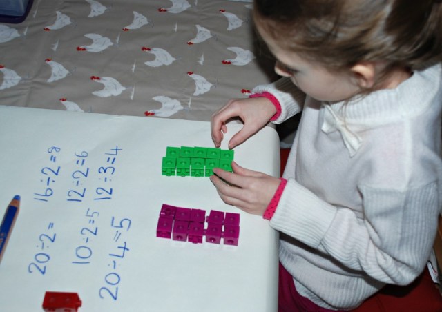 working out division by sharing our snap cubes into equal groups