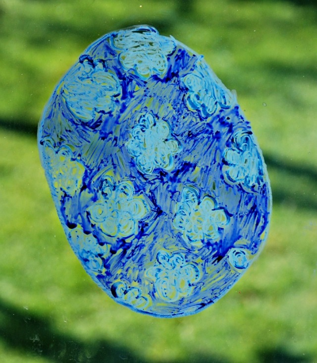 Easter Egg traced onto glass and then coloured in using Twinkl egg templates and STABILO pencils