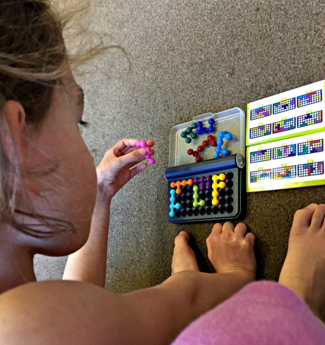 Playing our IQ fit game while she waits for her brother to finish an activity