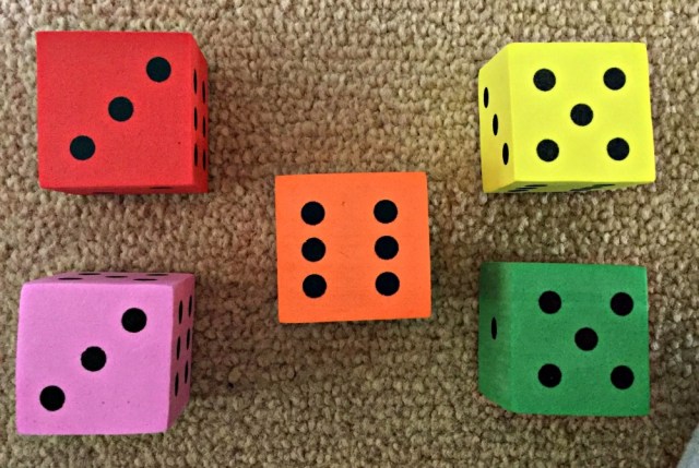 Using foam dice to help kids with sums where they need to regroup the numbers
