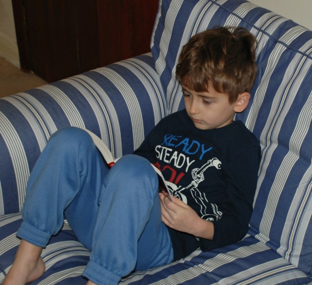 Reading the Railway Children to himself after having it read aloud as a family book