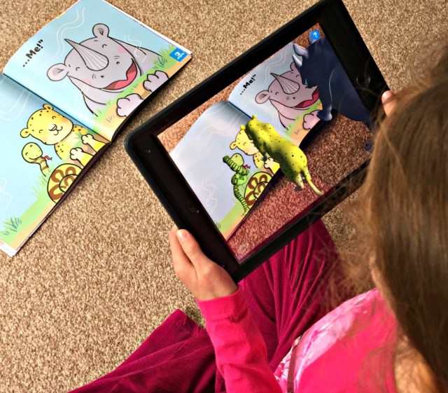 The Twinkl AR App being used on the Twinkl orginal story Ronald the Rhino. The App turns some of the pictures into 3D