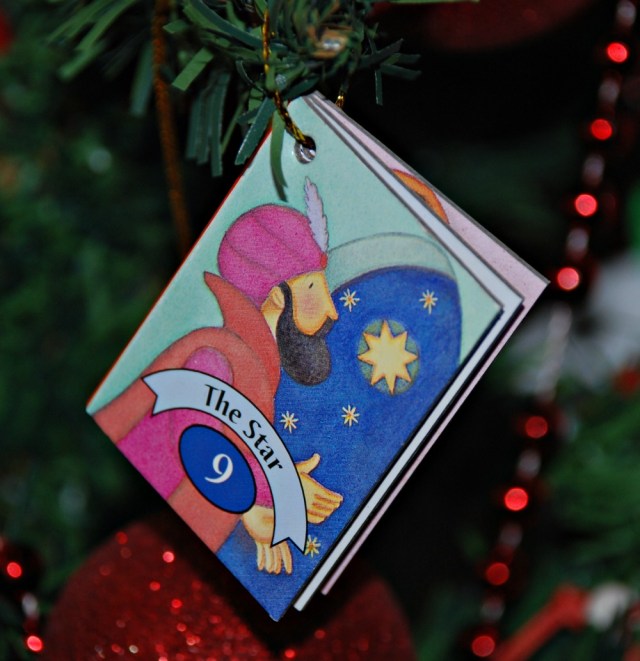 The Story of Christmas book set one of the books hanging on the Christmas tree