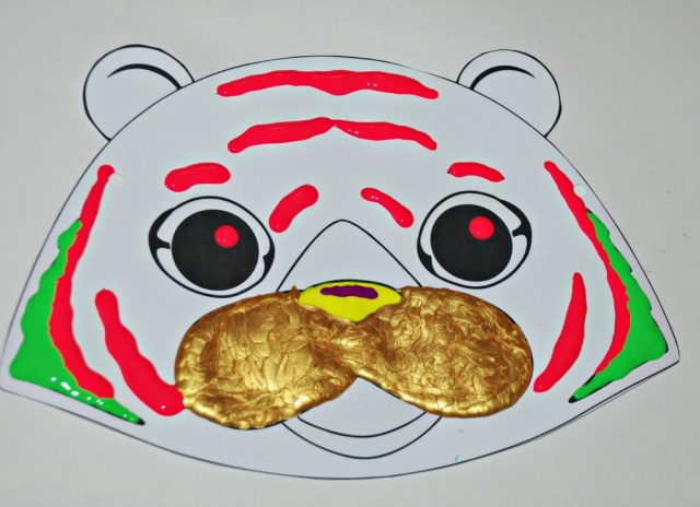 Black and white tiger mask from Activity Village decorated with dimensional paint