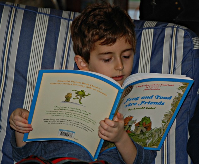 Reading Frog and Toad by Arnold Lobel to himself. A story book which becomes a good reader
