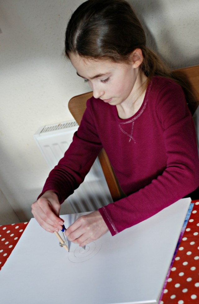 Creating for own geometry art picture using her Maths geometry Set