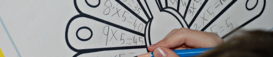 Writing out his 5 times table sums on the feathers of a peacock from the activity village website