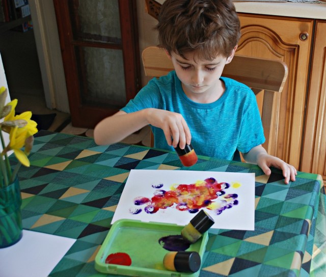 Using watercolour and paint dabbers to get colourful paper for art projects