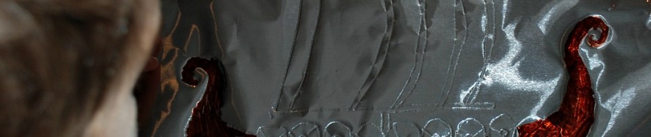 Colouring in our Viking Longship picture that we created on the tin foil