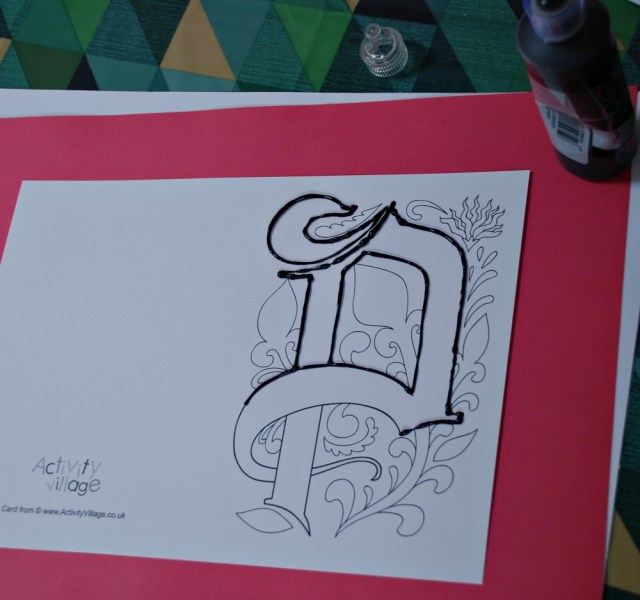 Outlinning the illuminated letters on the cards with dimensional paint