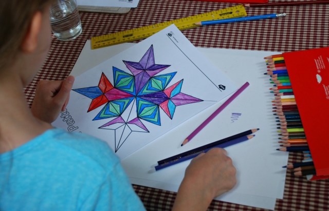 Using the Rangoli Pattern colouring pages from Twinkl to work on lines of symmetry