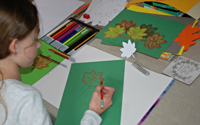 working on her autumn leaf pictures using her chalk pastels
