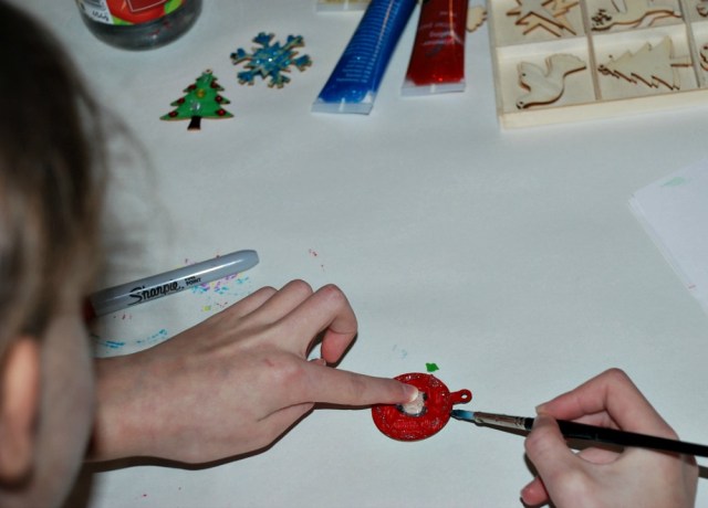 Addin the glitter paint to the Christmas ornaments that we bought from Flying Tiger