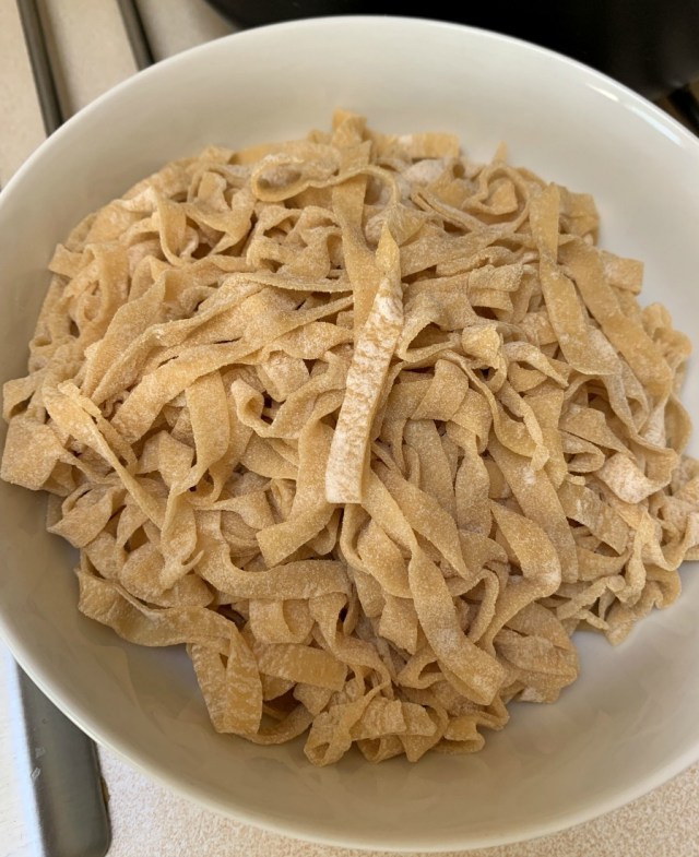 Using a pasta roller to make our own pasta