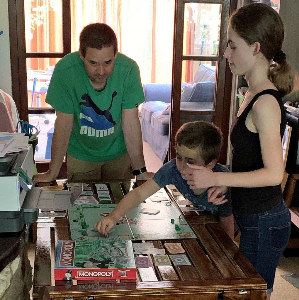 playing Monopoly. ofamily learning together